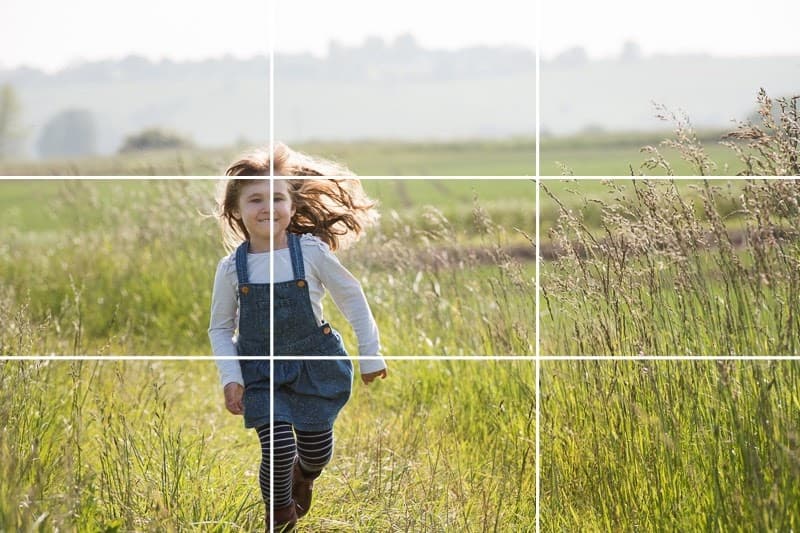 Rule of thirds grid positioning a running child along the left vertical line